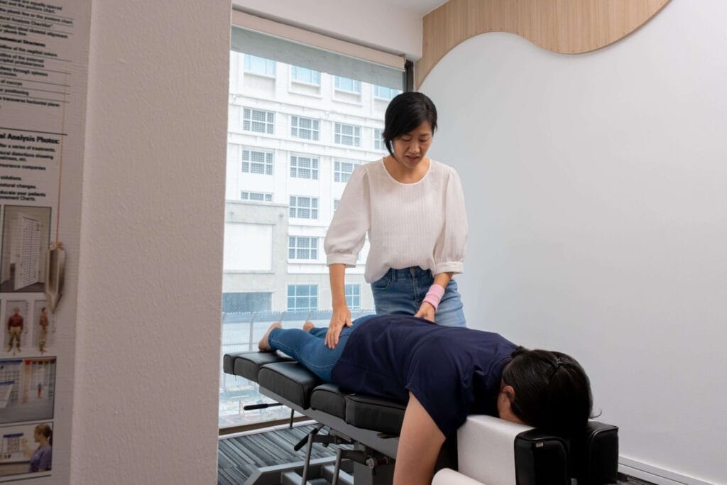 Dr Tao Lei with a patient at Kirolounge Bugis